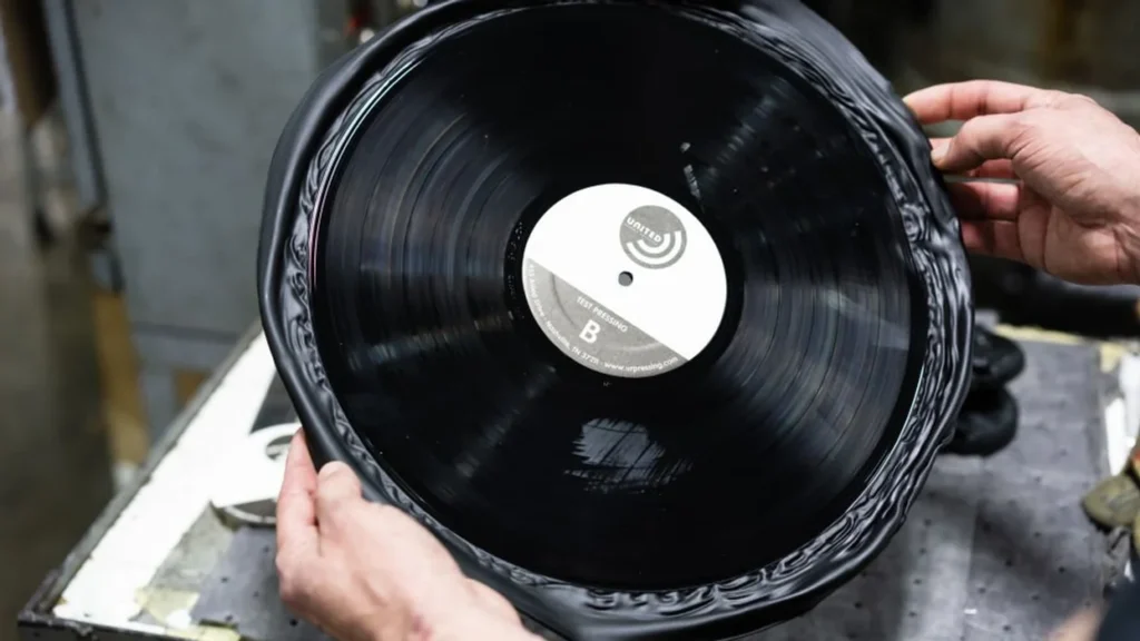 Blaze Media image of two hands holding an untrimmed vinyl record